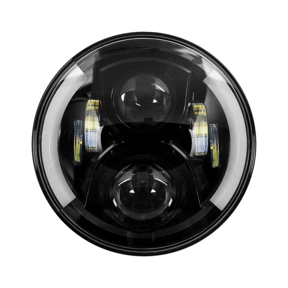 Front view of a round black motorcycle headlight with two projector lenses and partial halo
