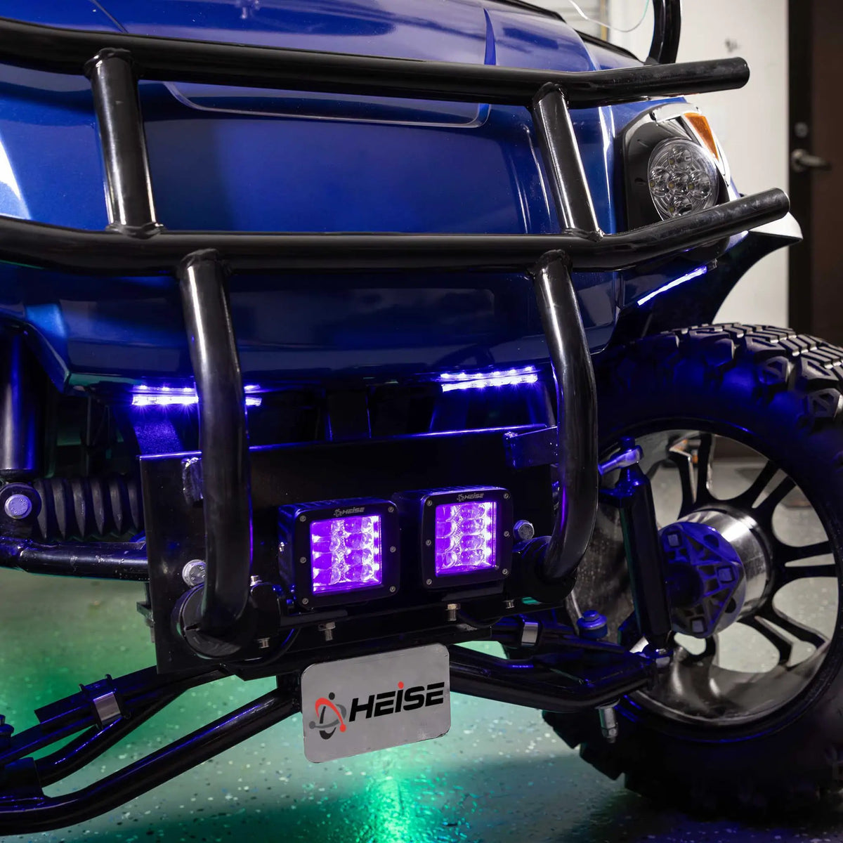 Blue and purple accent lights installed on a touring motorcycle, with green light beneath it