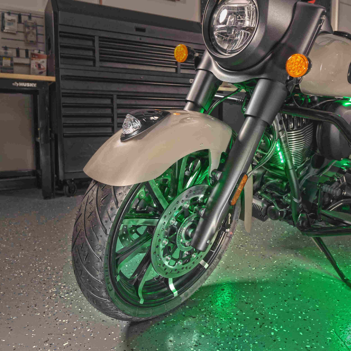 Motorcycle front wheel and fender illuminated by green accent lights