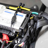 Installed motorcycle lighting wiring and connectors beside an electronic module