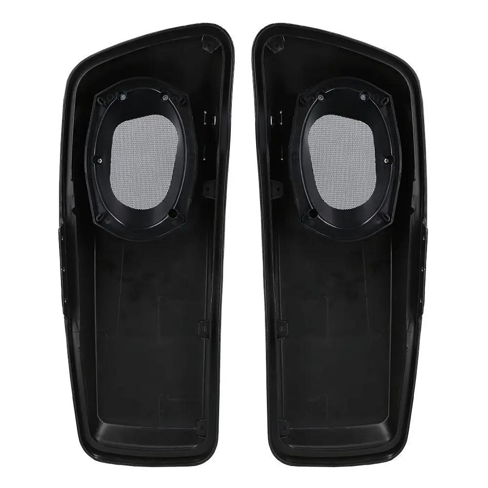 Undersides of two black saddlebag lids showing speaker openings and mounting points