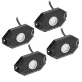 Four black rock-light pods with clear round lenses, mounting holes and attached cables