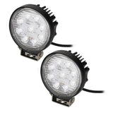 Pair of round LED driving lights with bright white lenses, finned housings and mounting brackets