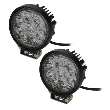 Pair of round LED driving lights with unlit lenses, finned housings and mounting brackets