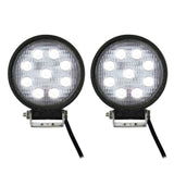 Two round driving lights illuminated white, showing nine LEDs in each light