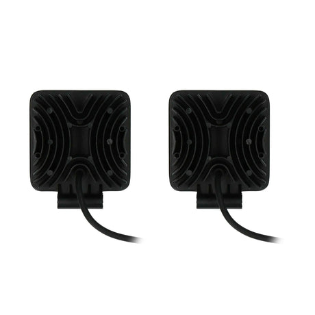 Rear view of two square driving lights with finned black housings and power cables