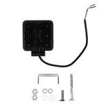 Rear of a square driving light with its cable and mounting hardware laid out beside it