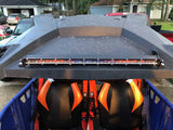 Slim LED light bar mounted above the orange and black seats of an off-road vehicle