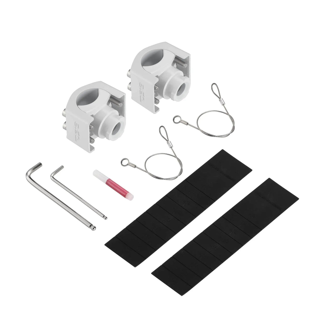 White mounting clamps, safety cables, hex keys, thread-locking tube and black rubber strips laid out