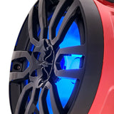 Close-up of a red speaker pod's black grille and central tweeter with blue illumination