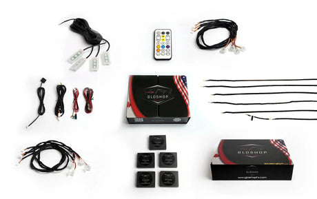 Gloshop lighting kit laid out with light strips, small LED modules, wiring, controller boxes and a remote