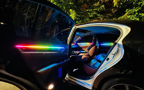 Open rear car door with a rainbow-colored light strip and illuminated cabin