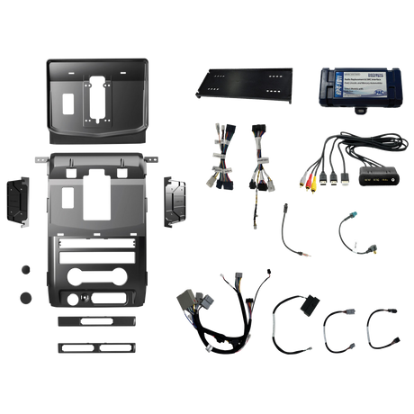 Radio installation components laid out with dashboard panels, mounting brackets, interface modules, wiring harnesses and adapter leads
