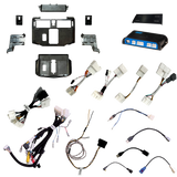 Radio installation components laid out with dashboard panels, brackets, an interface module, wiring harnesses and adapter leads