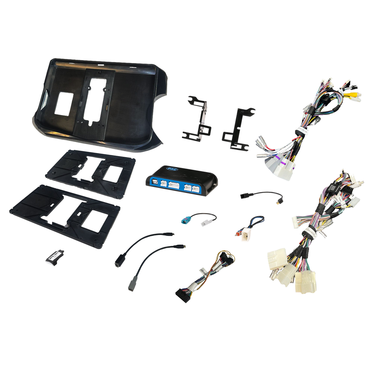 Radio installation components laid out with dashboard panels, brackets, an interface module and wiring adapters