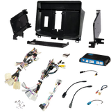 Radio installation components laid out with a dashboard panel, mounting brackets, interface module and wiring adapters