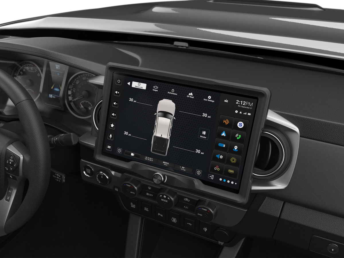 Wide touchscreen installed above dashboard climate controls, displaying vehicle tire-pressure information