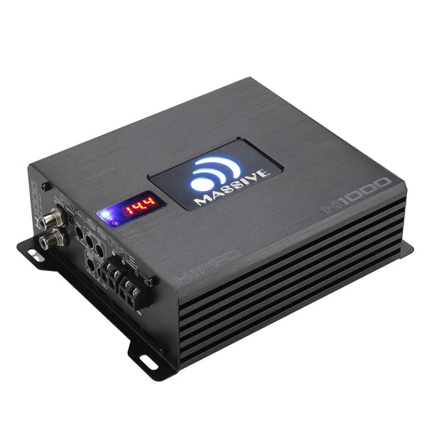 Angled view of a black Massive Audio H1000 amplifier with an illuminated logo and a 14.4 voltage display