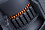 Close-up of a black subwoofer basket with narrow vent slots and orange fins