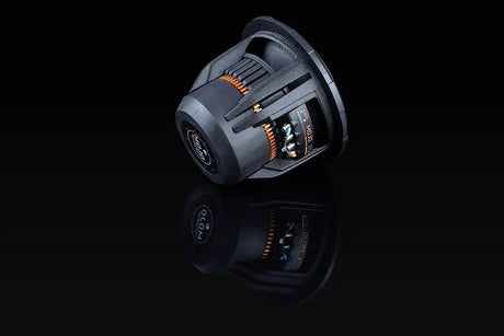 Angled rear of a Memphis MOJO subwoofer, showing its large magnet, open basket and orange vent details