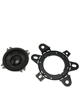 Small round Memphis speaker beside a black mounting adapter ring with multiple tabs