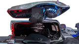 Blue illuminated speaker and wiring installed beneath an open motorcycle saddlebag lid