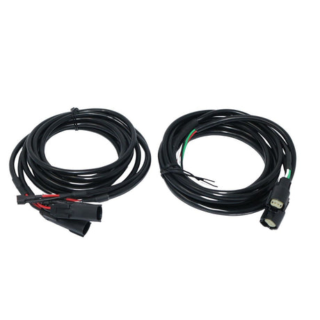 Two coiled black speaker wiring harnesses with connector plugs