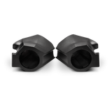Two empty black molded speaker pods with round speaker openings