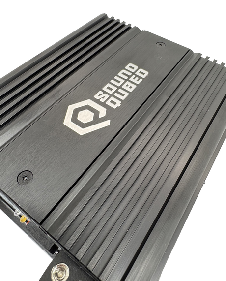 Close-up of a SoundQubed amplifier's brushed top panel and parallel cooling fins