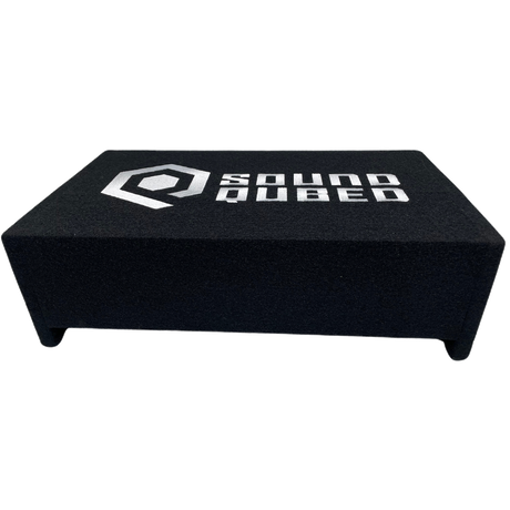 Top view of a low black carpeted SoundQubed enclosure with a large white logo and short feet