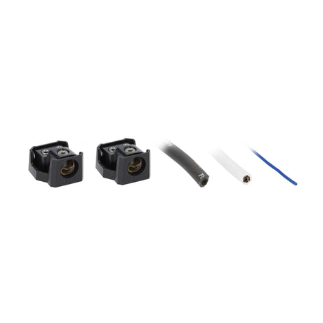 Two uncovered power distribution blocks with black and white cable ends and a blue wire
