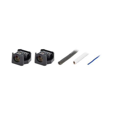 Angled view of two uncovered power distribution blocks with cable ends and a blue wire