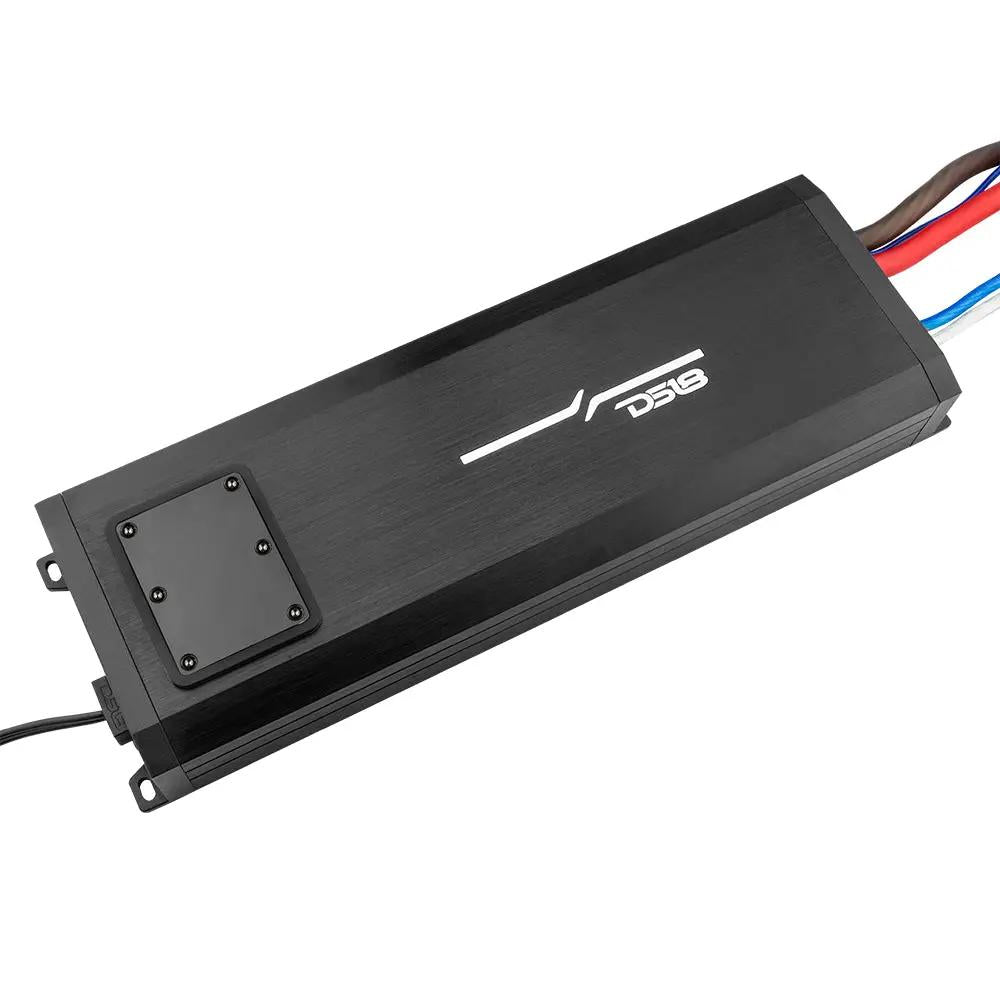 Angled overhead view of a black DS18 amplifier with its control-panel cover fitted and wiring at both ends