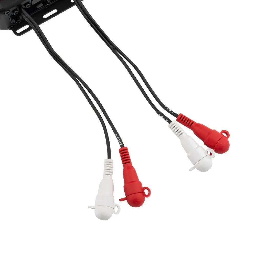 Close-up of four red and white capped RCA connectors on amplifier leads