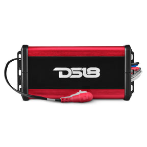 Top view of a red and black DS18 amplifier with red and white RCA leads across its front