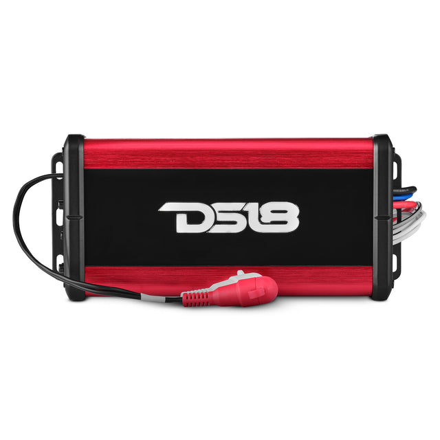 Top view of a red and black DS18 amplifier with red and white RCA leads across its front