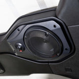 Installed round speaker grille and small tweeter in a black molded vehicle speaker pod