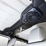 Speaker pod installed overhead beside a vehicle roll bar