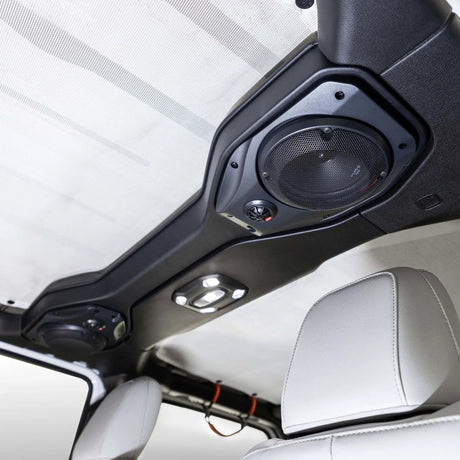 Speaker pod installed overhead beside a vehicle roll bar