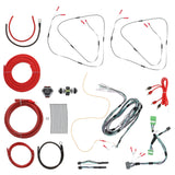 Wiring harnesses, red power cables, RCA leads, fuse holder and cable ties arranged on white