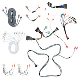Audio wiring harnesses, coiled RCA cables and speaker adapters arranged on white